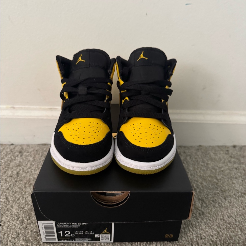Kids Jordan 1s black and yellow